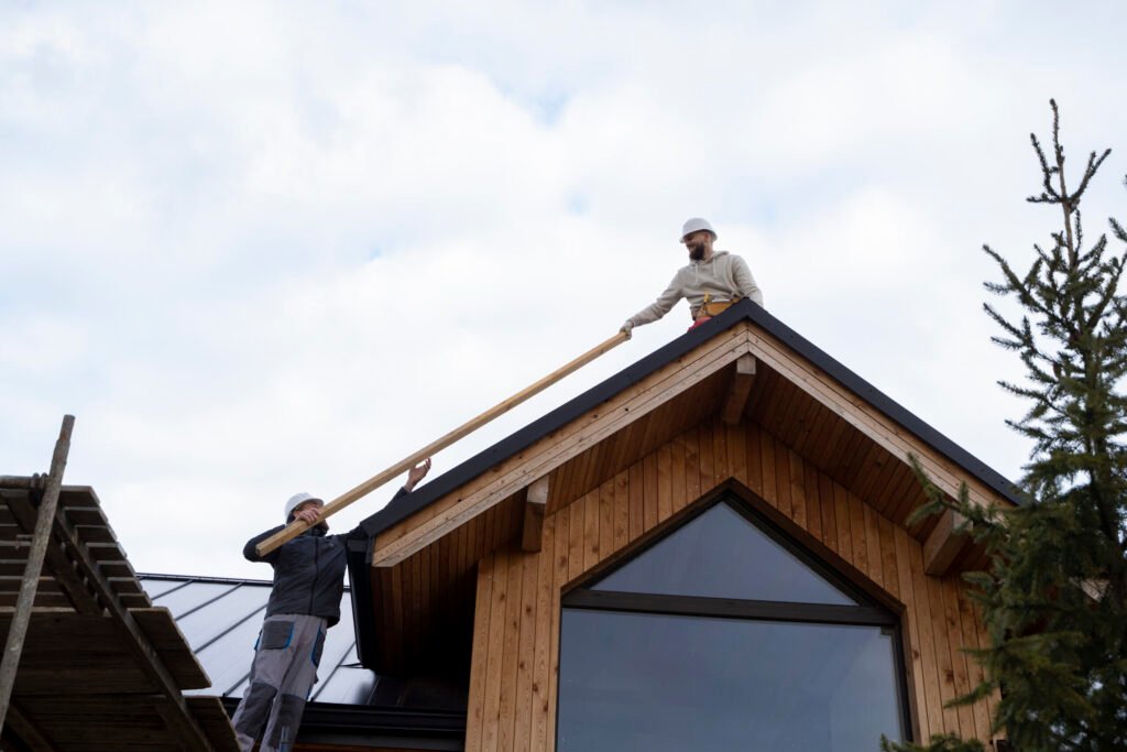 long shot men working roof scaled 1.jpg